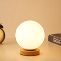 Modern Globe Glass Table Lamp with Wood Base Accent | Lumetriq